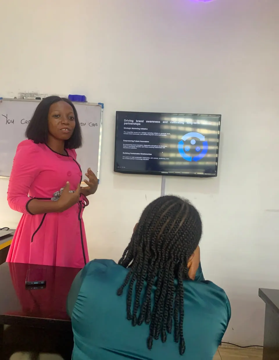 A team member presenting a strategy session on a wall-mounted screen