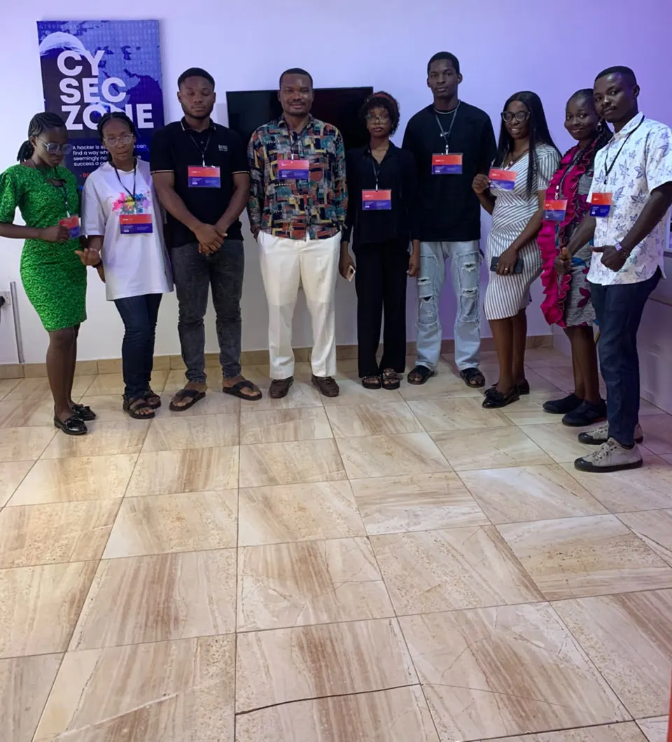 A cohort lined up together after a training session, wearing lanyards