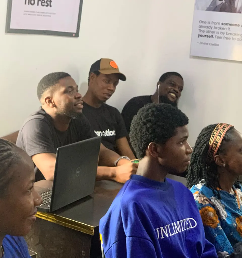 Students gathered around a laptop during peer learning
